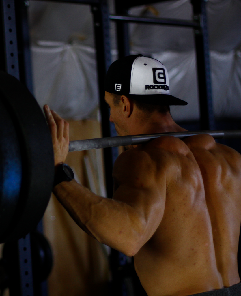 OG Snapback Hat man lifting weights while wearing the o g rockwell black/white snapback hat
