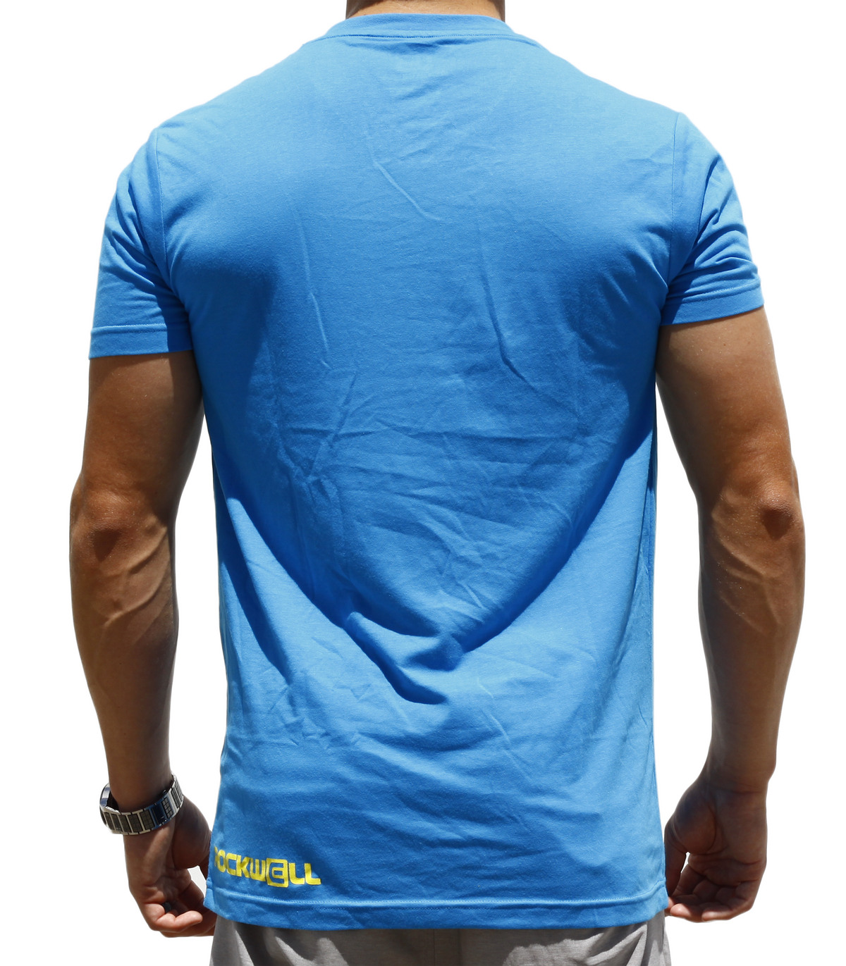 backside of man wearing blue boss v neck. Rockwell logo on the bottom left 